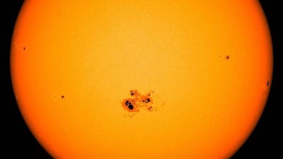 A gigantic sunspot – almost 80,000 miles across -- can be seen on the lower center of the sun in this image from NASA’s Solar Dynamic Observatory captured on Oct. 23, 2014. This active region, named AR2192, is the largest of the current solar cycle. Ten Earth's could be laid across its diameter. Credit: NASA/SDO