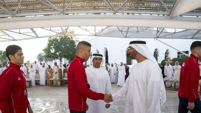 Sheikh Mohamed bin Zayed greets a member of Asian Muay Thai Championship 2019, during a Sea Palace barza. Mohamed Al Hammadi / Ministry of Presidential Affairs