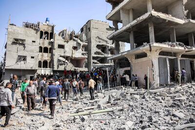 People gather to search for survivors and victims through the rubble following Israeli bombardment in the Zarqa neighbourhood in Gaza city. AFP