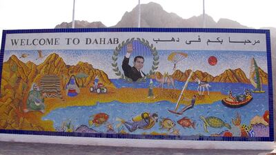 Dahab on Egypt’s Sinai Peninsula is famous for freediving but is fast becoming a bohemian enclave. Former president Hosni Mubarak remains on its sign despite his fall from power. joko / ullstein bild via Getty Images.