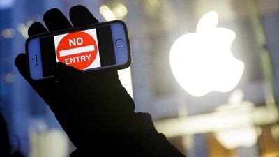 A man holds up an iPhone displaying a ‘No Entry’ image as part of a rally in front of an Apple Store in support of the company’s privacy policy, in New York in February. The US Justice Department said the FBI had accessed the iPhone used by one of the shooters in the San Bernardino, California, terrorist attack. Justin Lane / EPA