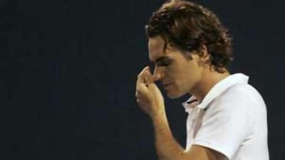 Federer leaves the court after being defeated by Gilles Simon in Toronto.