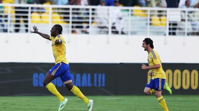Makhete Diop of Al Dhafra (left) celebrates scoring his 100th goal for the club, during the Arabian Gulf League football match between Al Dhafra and Al Ain, at Hamdan Bin Zayed Al Nahyan Stadium. 13 March 2015. Adil Alnaimi / Al Ittihad