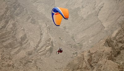 Paraglide through the mountains of Musandam, ahead of checking in at Six Senses Zighy Bay. Andrew Parsons / The National