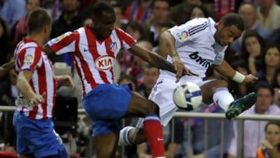 Real's Marcelo jumps past a challenge from Atletico's Luis Amaranto Perea, who later saw red.