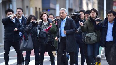 Members of the media surround Junichiro Hironaka the Japanese lawyer for former auto tycoon Carlos Ghosn as he walks to his office in Tokyo. AFP