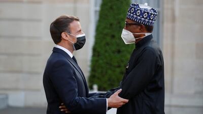 French President Emmanuel Macron welcomes Nigerian President Muhammadu Buhari for a dinner with leaders of African states and international organisations on the eve of a summit on aid for Africa, at Elysee Palace in Paris, France. Reuters