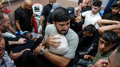 Relatives and friends of Waleed Nidal Waleed Abu Sneineh, a 16-year-old Palestinian boy reportedly shot dead by Israeli forces, mourn over his body at a hospital in Ramallah. AFP