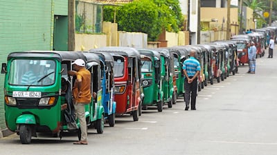 Auto rickshaw drivers queue to buy fuel in Colombo on July 3. AFP Photo