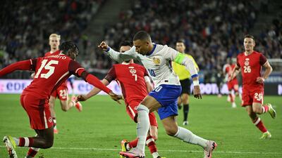 Kylian Mbappe takes on Stephen Eustaquio and Moise Bombito during the friendly match between France and Canada. EPA