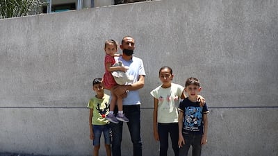 A family made homeless after their building, the Hanadi highrise, was destroyed by Israeli air strikes. Rakan Abed El Rahman for The National