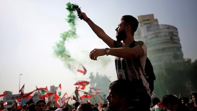 A demonstrator holds a flare during ongoing anti-government protests near the Ministry of Education and Higher Education in Beirut, Lebanon on November 7, 2019. Reuters.
