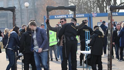 Fans are checked by security at the entrance to the stadium. EPA