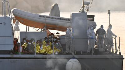 File photo: Migrants warmed by emergency blankets arrive on a boat of the Italian Guardia Di Finanza law enforcement agency on May 17, 2021 to disembark on the southern Italian Pelagie Island of Lampedusa. AFP