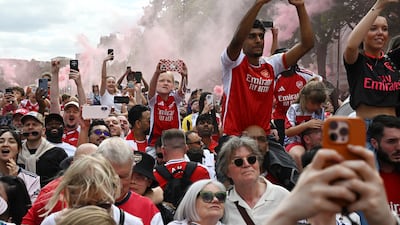 Arsenal fans participate in their team's victory parade in London. Reuters