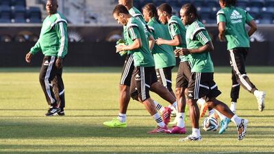 Nigeria players warm up on Monday as they take part in a training session ahead of the 2014 World Cup. NIcholas Kamm / AFP / June 2, 2014