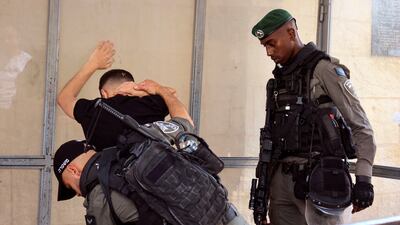 Israeli border police search a Palestinian man in Jerusalem's Old City. Reuters