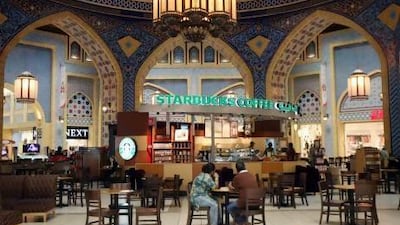 The classic Arabian decor in the Ibn Battuta Mall in Dubai contrasts with the many shop fronts and advertising slogans in English. Some experts blame globalisation for a decline in Arabic. Randi Sokoloff / The National