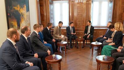 Syrian President Bashar Assad meets with Russian politicians, in Damascus, Syria, to complain of a campaign of 'lies' by Western powers. (SANA via AP)