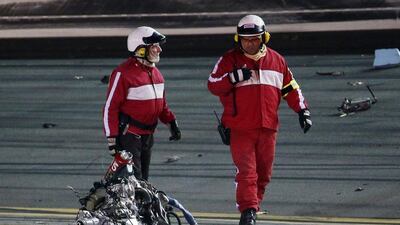 Track workers pass the engine block of Austin Dillon's No 3 Bass Pro Shops Chevrolet on Monday morning after the Nascar Coke Zero 400 at Daytona International Speedway. Chris Graythen / Getty Images / AFP