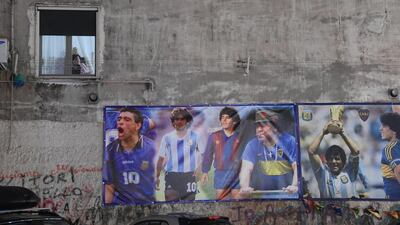 A series of posters of Diego Maradona stand out on a wall in Naples, Italy. EPA