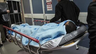 An Israeli soldier is wheeled through a hospital in Ashkelon, Israel, on February 7, 2016. The soldier was stabbed in the torso near the central bus station in Ashkelon and the attacker was shot and apprehended. Tsafrir Abayov/AP Photo