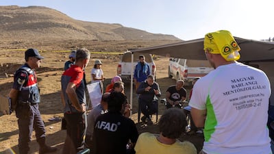 Rescuers hold a meeting near the Morca Cave as a rescue operation continues to reach U. S. caver Mark Dickey. Reuters
