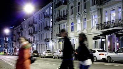 People cross an Oslo street at night-time. Naess’s latest novel in English translation, which is plotted around the disappearance of a 12-year-old girl, is set in the Norwegian capital. Tomm W. Christiansen / Bloomberg