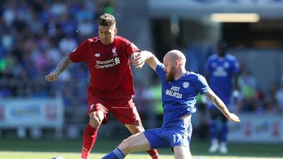 Liverpool's Roberto Firmino, left, 'has a small tear in a very small muscle', according to Jurgen Klopp. David Davies / AP Photo