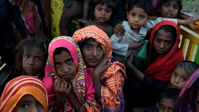 Children prepare to leave the coastal area of Golarchi in Badin district, Pakistan. AP