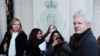 Julian Assange arrives at the Supreme Court in London yesterday to appeal against his extradition to Sweden. Several dozen supporters were outside the court, cheering and singing Bob Dylan songs as he arrived for the start of the two-day hearing.