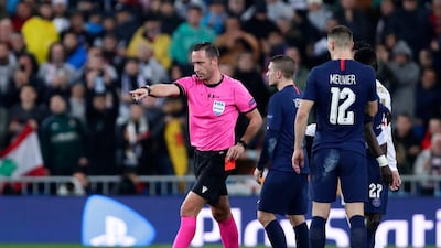 Referee Artur Dias points to the penalty box before watching the VAR monitor and cancelling his decision to award PSG a penalty. AP