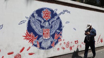 A man walks past a wall of the former US embassy, with an anti-America mural on it, in Tehran this month. Reuters