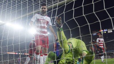 Granada goalkeeper Guillemo Ochoa tangled in his own net after Barcelona's Rafinha scored during the Primera Liga match at Camp Nou in Barcelona, Spain, Saturday, October 29, 2016. Manu Fernandez / AP Photo