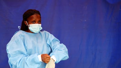 A health worker wears protective clothing as she prepares to test travellers at the Grasmere Toll Plaza, in Lenasia, South Africa. Reuters