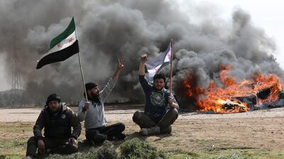 Syrians block the main highway in Neyrab in protest at the agreement on joint Turkish and Russian patrols in northwest Syria. AP
