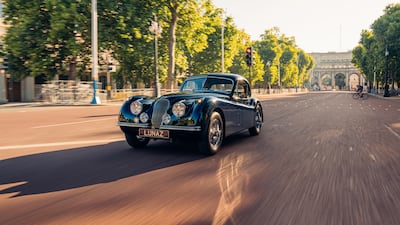 The XK120 heads down The Mall, London, in the direction of Buckingham Palace.