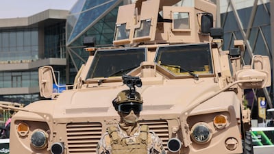 A member of Saudi Arabia's special armed forces stands in front of a military vehicle at the World Defence Show. AFP