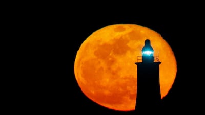 The biggest full moon of 2020 rises behind a lighthouse in Valletta, Malta. Reuters
