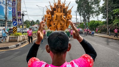 A crew member directs a wax float as it is driven through the streets on the first day of the Ubon Ratchathani Candle Festival in Ubon Ratchathani, Thailand. EPA