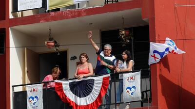 People are seen on a balcony as they await Pope Francis's arrival. Reuters