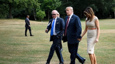 US President Donald Trump and First Lady Melania Trump walk with US Ambassador to the United Kingdom Woody Johnson as they arrive at the US ambassador's residence Winfield House in London. AFP