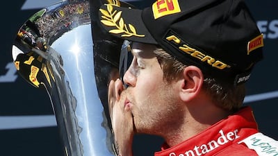 Sebastian Vettel kisses the trophy after winning the Hungarian Grand Prix for the first time. Laszlo Balogh / Reuters