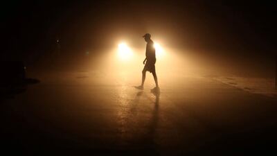 A beachgoer heads to his car long after sunset in Solana Beach following a record-setting day of temperatures according to local media, in Southern California. Mike Blake / Reuters