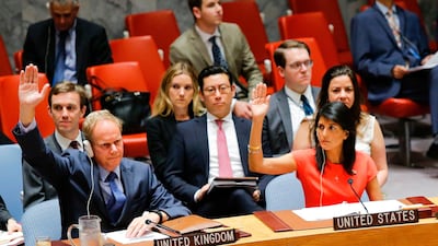 US ambassador to the United Nations Nikki Haley, right, and Britain's ambassador Matthew Rycroft vote on a US-drafted resolution toughening sanctions on North Korea
