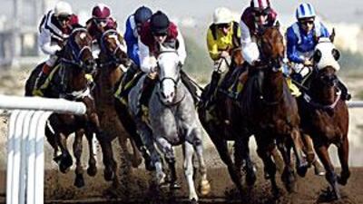 William Buick aboard Dahteer (third in from right in yellow top) on his way to winning the Dh90,000 Emirates NBD Benchmark Handicap.