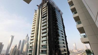 High-rise buildings with flammable cladding will need to adopt new fire safety measures including outdoor sprinklers under rules announced by Civil Defence chiefs. Pawan Singh / The National