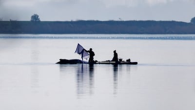 A rescuer uses a paddle to place wet towels over a stranded humpback whale off the island of Poel in a bid to save its life, near Wismar, Germany. Getty Images