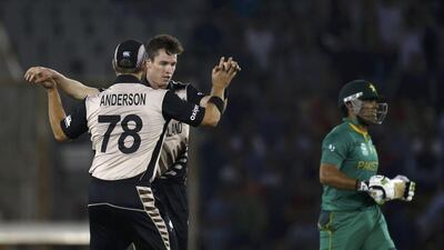 New Zealand's Adam Milne celebrates with his teammate Corey Anderson after taking the wicket of Pakistan's Umar Akmal. REUTERS/Adnan Abidi