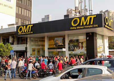 People gather in a long line at a shop in Beirut that provides money transfer services. AFP